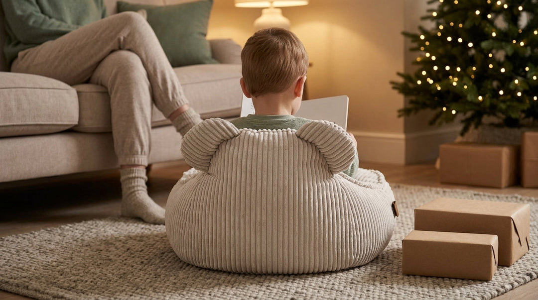 Toddler reading in an ecru children's bean bag with soft ears in a living room at Christmas