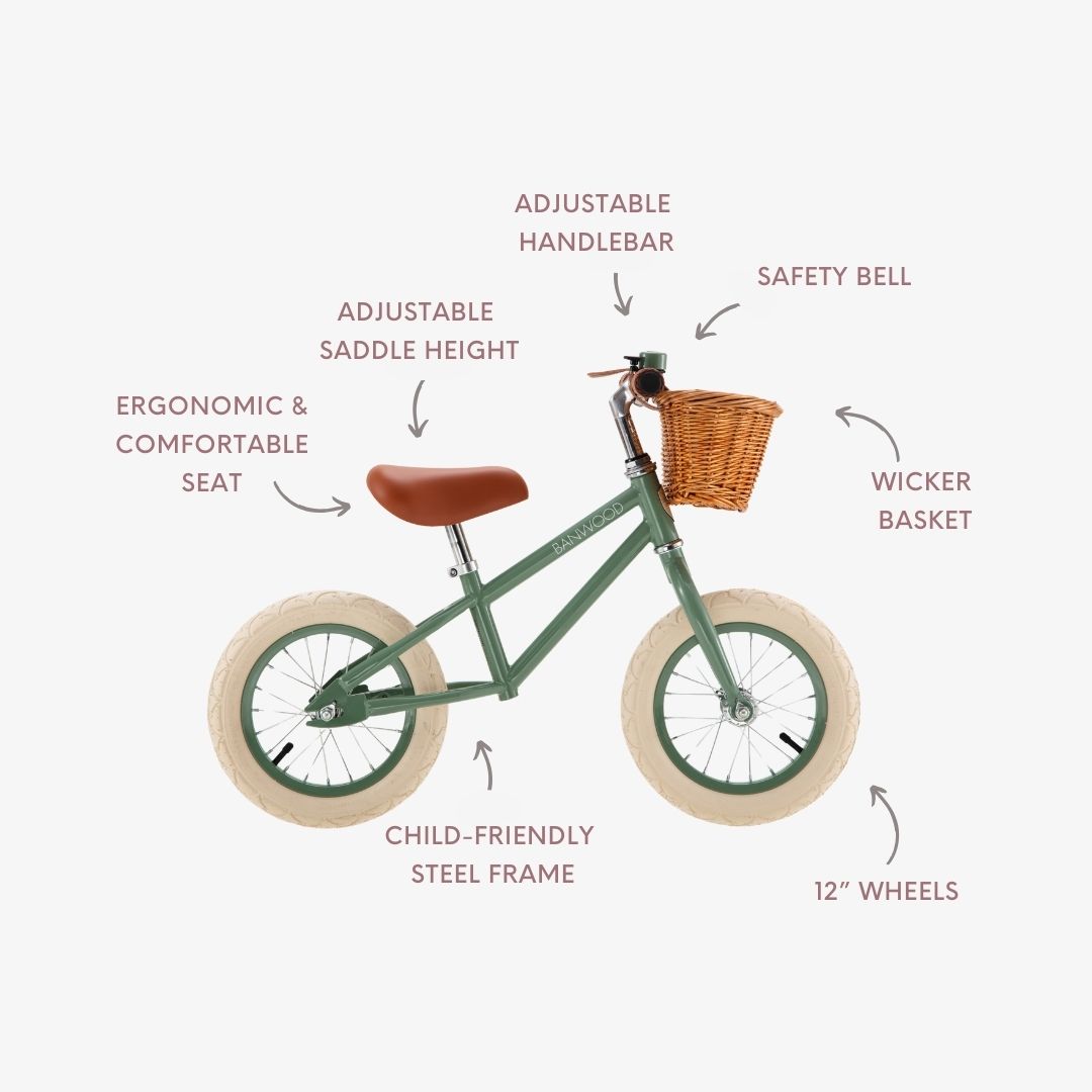 Balance bike feature diagram labelling adjustable saddle, handlebar, safety bell and wicker basket