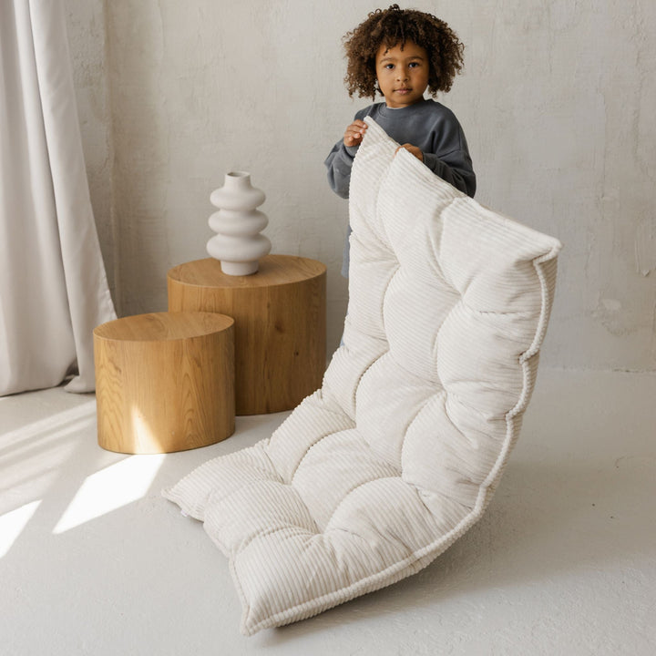 MINICAMP ecru tufted floor cushion laid flat as a floor mattress