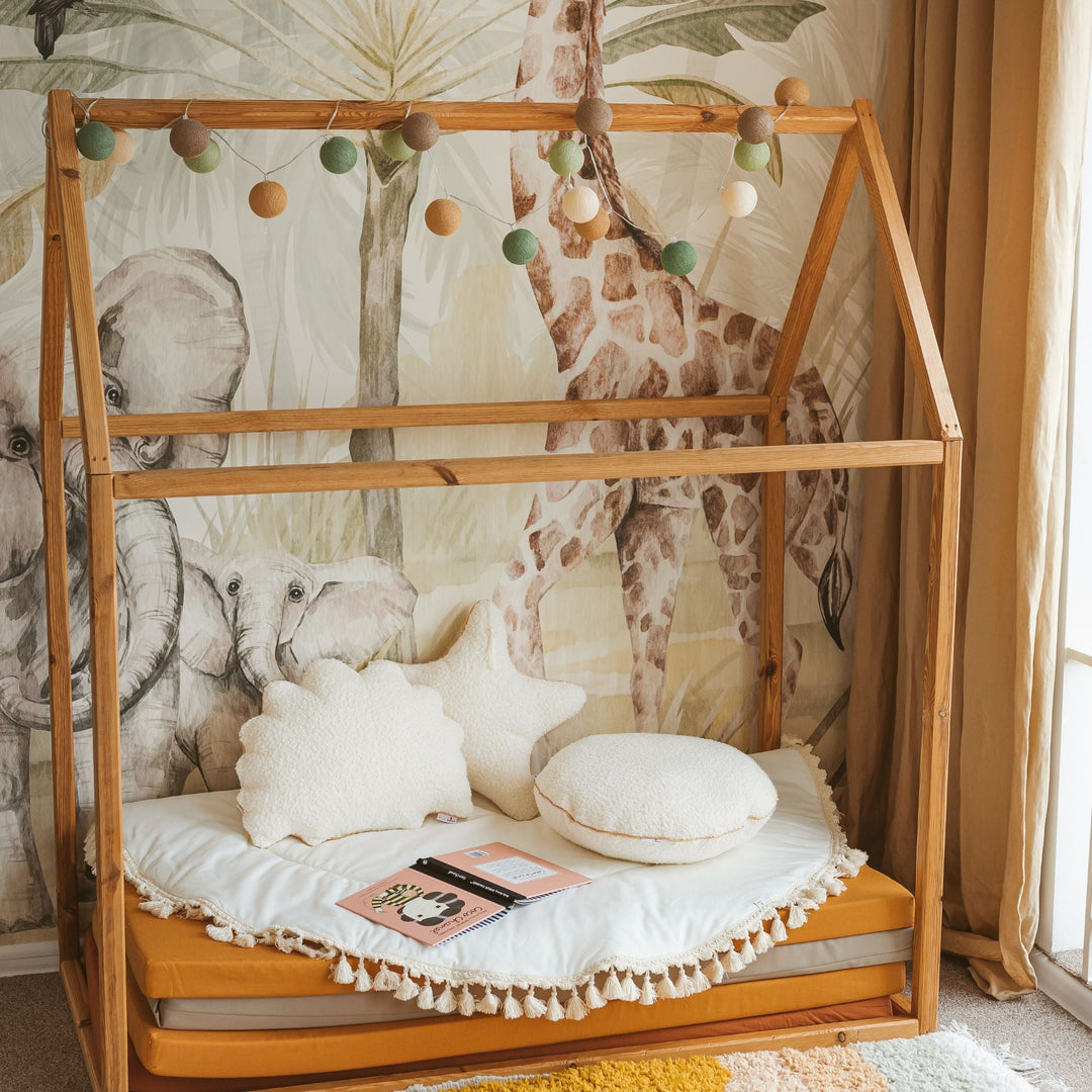 Ecru bouclé seashell cushion, side angle showing scalloped shape