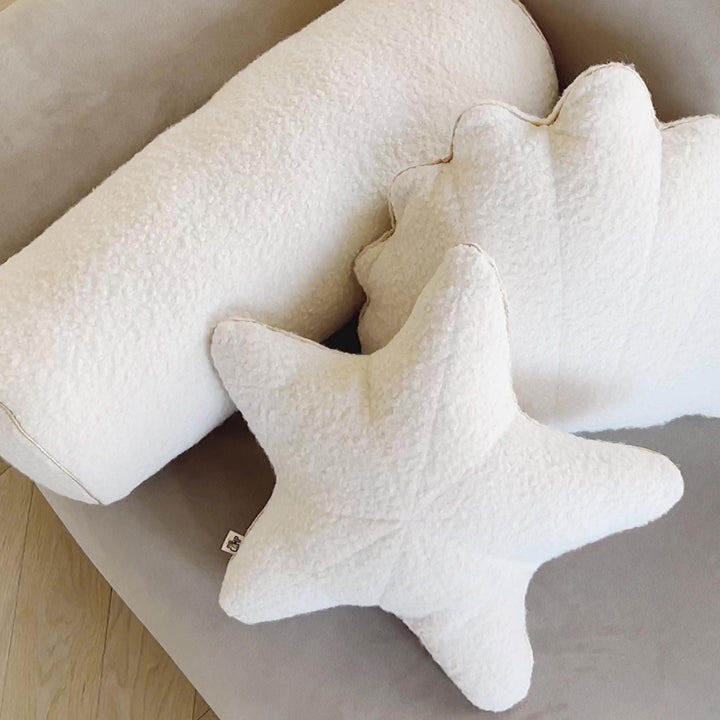 Close-up of golden metallic trim on ecru bouclé starfish cushion