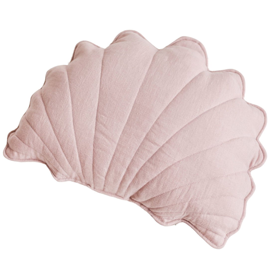 Pink linen seashell cushion styled with a matching starfish cushion on a rattan chair