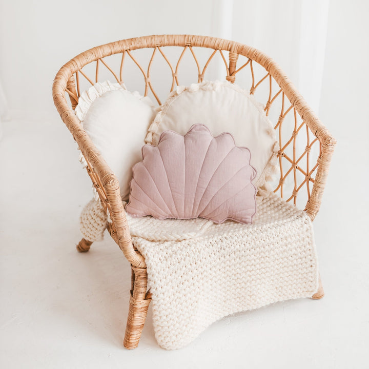Pink starfish-shaped cushion from the MINICAMP coastal cushion range on a rattan chair