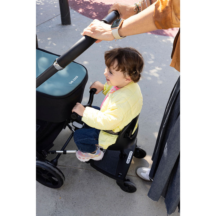 Be Cool Skate platform with seat and soft-grip handle attached, showing toddler riding position