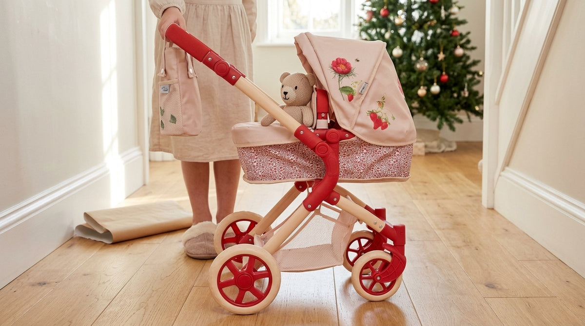 Roma RHS Single Dolls Pram in Flora with a teddy in the carry cot in a hallway on Christmas morning