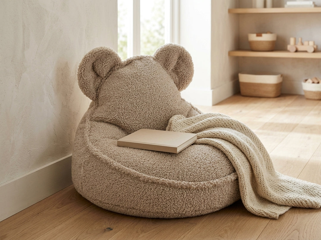 Wigiwama Bear Beanbag with a knitted blanket and a book in a quiet playroom corner