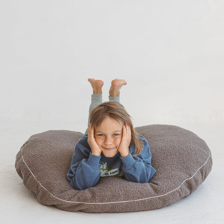 MINICAMP grey boucle floor cushion showing the removable cover