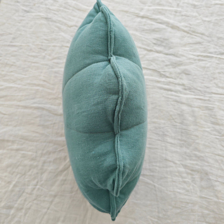Mint linen seashell cushion, front view showing quilted shell shape