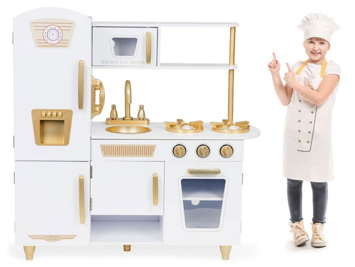 A child in a chef hat and apron beside the MeowBaby White &amp; Gold Wooden Play Kitchen