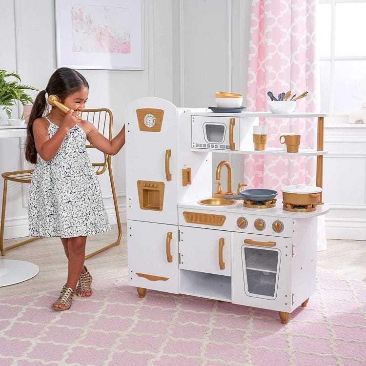 A child playing with a play telephone beside the MeowBaby White &amp; Gold Wooden Play Kitchen