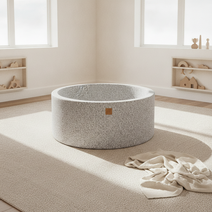 MeowBaby Boucle Marled Grey Round Ball Pit on a rug in a bright playroom