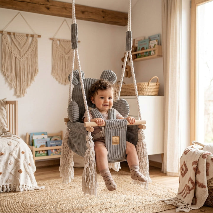 Baby sitting in the MeowBaby Bear Swing in a cozy nursery